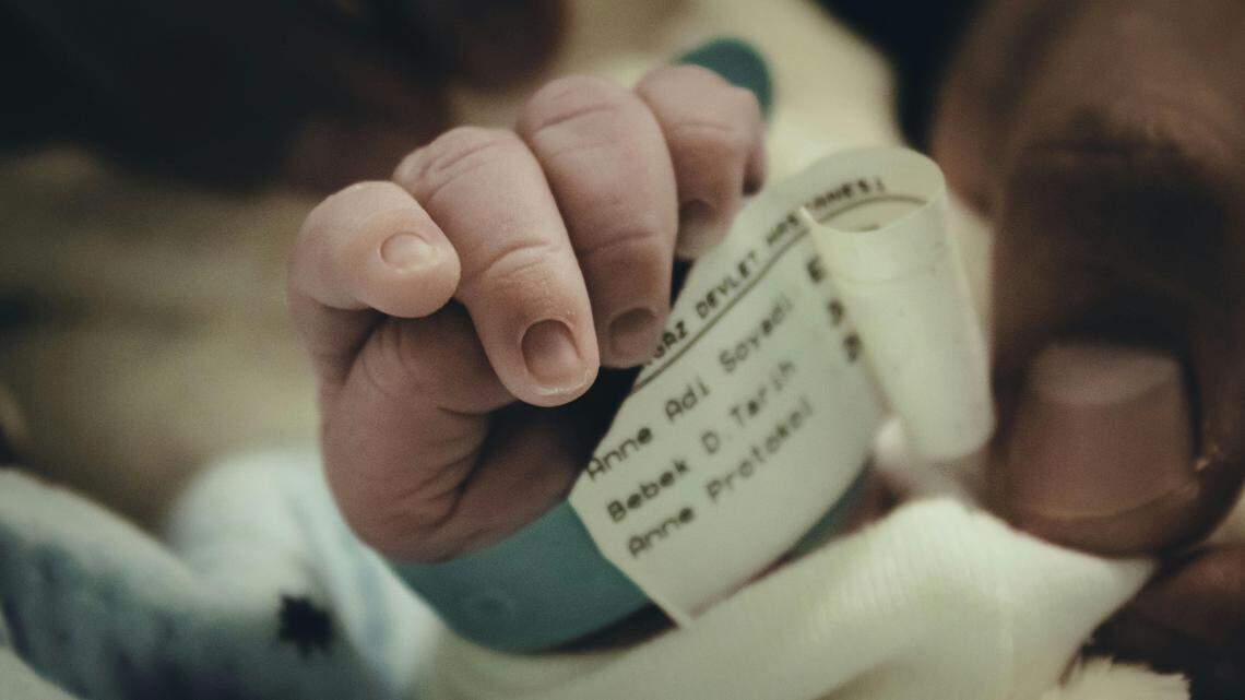 newborn baby making fist hospital