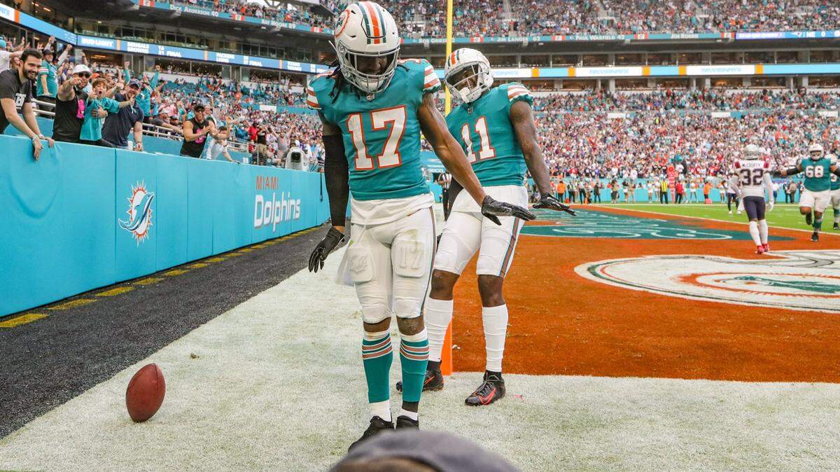 Miami Dolphins wide receiver Jaylen Waddle (17) and wide receiver DeVante Parker (11) do the waddle after Waddle scores in the first quarter against the New England Patriots at Hard Rock Stadium in Miami Gardens on Sunday, January 9, 2022.
