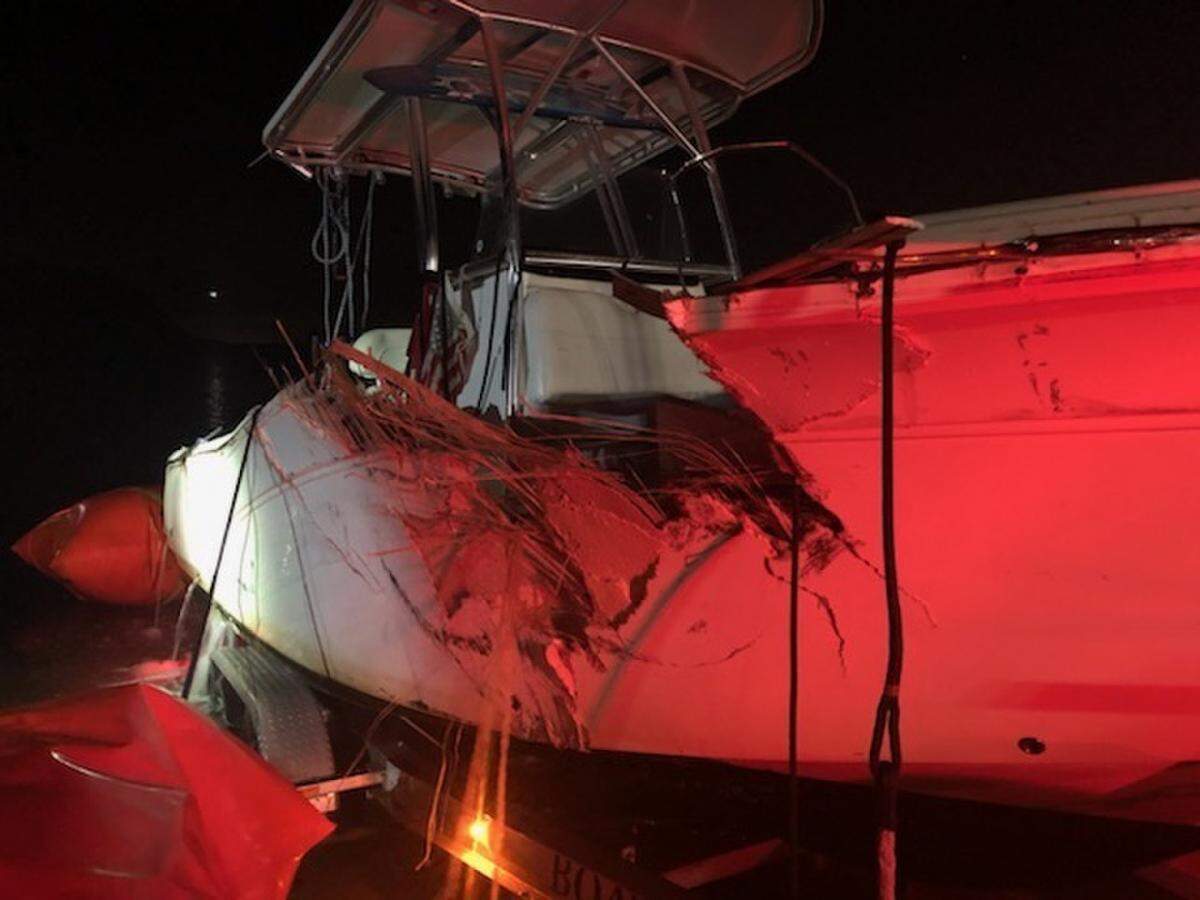 A center console boat with a large gash on its hull sits on a trailer Monday night, Jan. 4, 2021. The vessel was one of two involved in a collision off Key Biscayne that night.
