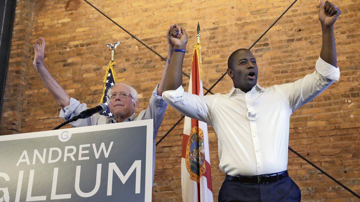 U.S. Sen. Bernie Sanders, I-Vt, left, and Democratic gubernatorial hopeful Andrew Gillum fire up a crowd of about 1,000 during a campaign rally on Friday, Aug. 17, 2018, in Tampa.