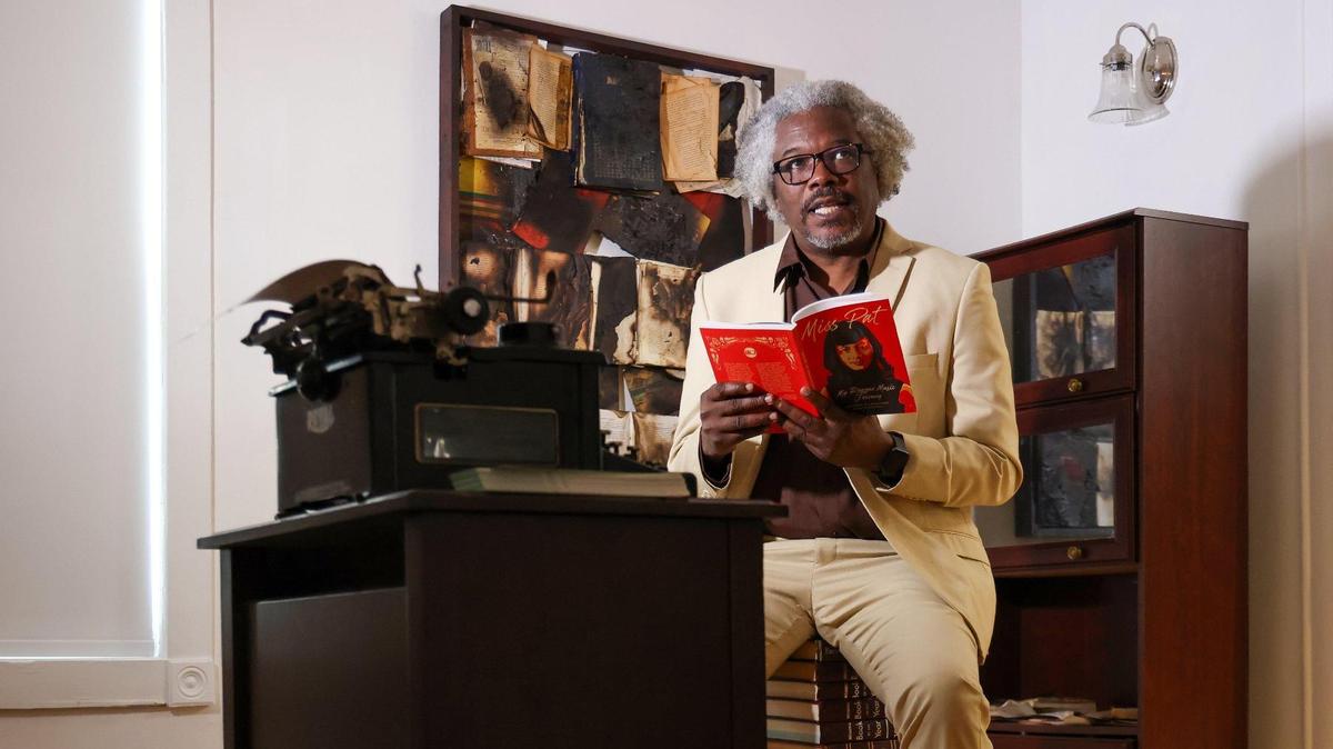 Artist Jessie Coleman, Jr. reads inside the D.A. Dorsey House in Overtown where the exhibition “On the Ban Wagon: The Power of the Pen,” which delves into a pivotal chapter of history through the lens of banned books, that is currently on display.