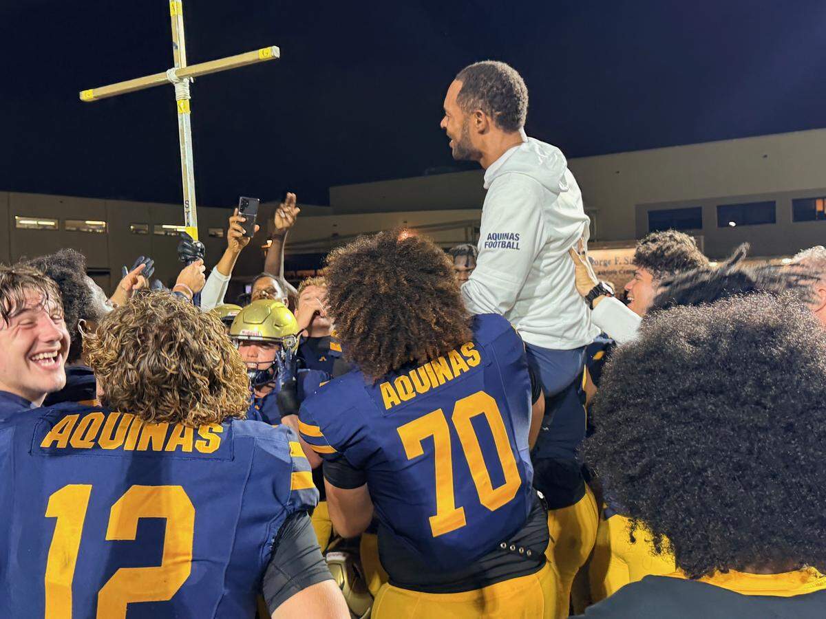 St. Thomas coach Roger Harriott is lifted onto his players shoulders in celebration of the victory over Fort Myers Riverdale in a Class 5A state semifinal on Friday at St. Thomas Aquinas in Fort Lauderdale, Fla.