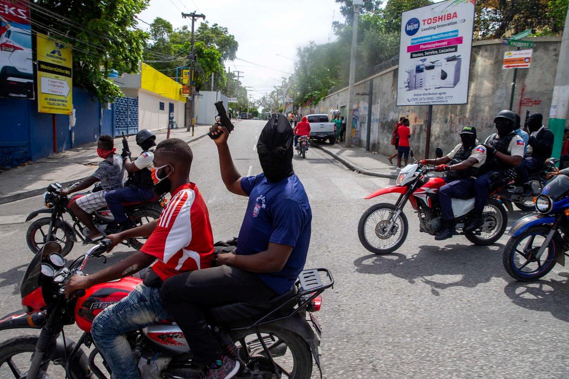 Haiti National Police officers hold up their weapons as they protest for better working conditions and the release of jailed officers in Port-au-Prince, Haiti, Monday, Sept. 14, 2020. The protest was called for by a nationwide police group called “Fantom 509,” which is associated with the police union.