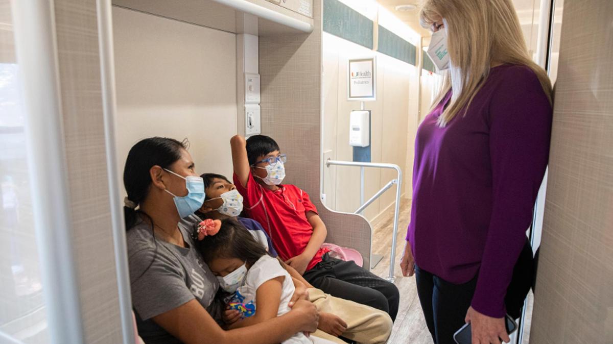 Dr. Lisa Gwynn, right, a University of Miami pediatrician and president of the Florida chapter of the American Academy of Pediatrics, at a UM mobile clinic in Homestead on June 24.