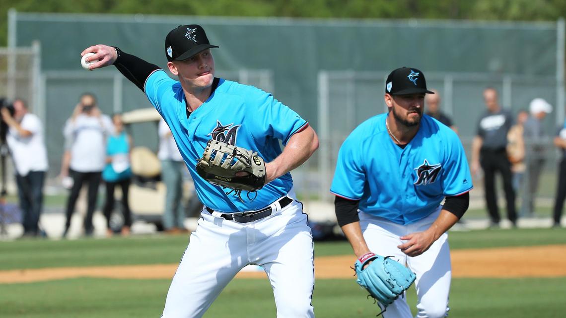 Miami Marlins outfielder Garrett Cooper (26) and pitcher Caleb Smith (31) running drills during the first full-squad spring training workout on Monday, February 18, 2019 in Jupiter, FL.