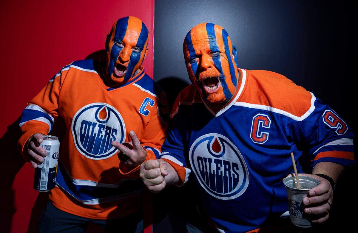 Edmonton Oilers fans Greg Weinrauch, 51, left, and Shawn Larson, 50, cheer as they arrive to the Amerant Bank Arena to watch their team play against the Florida Panthers in Game 7 of the Stanley Cup Final