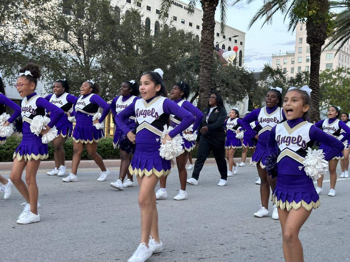 The Prymus Angels All-Stars Cheerleaders bring the holiday spirit to the 75th Annual Junior Orange Bowl Parade along Miracle Mile in Coral Gables on Dec. 10, 2023.