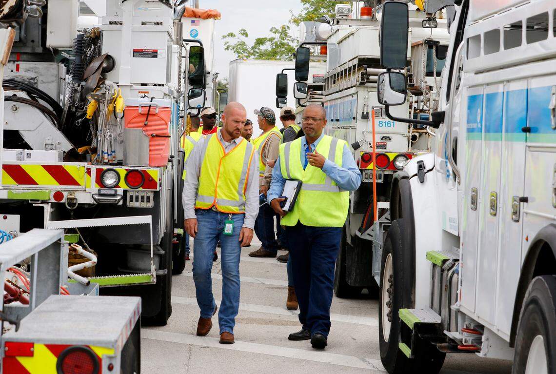 Wade Jollimore (left), Broward County distribution operations leader for Florida Power & Light Company, confers with Darryl Comer, Broward County distribution operations lead for FPL, as they prepare bucket trucks and crews to leave from the West Palm Beach Service Plaza on Florida’s Turnpike in Lake Worth, Fla., Sept. 11, 2018. More than 500 FPL employees and contractors left South Florida to help restore power to the Carolinas that are anticipated to be impacted by Hurricane Florence.