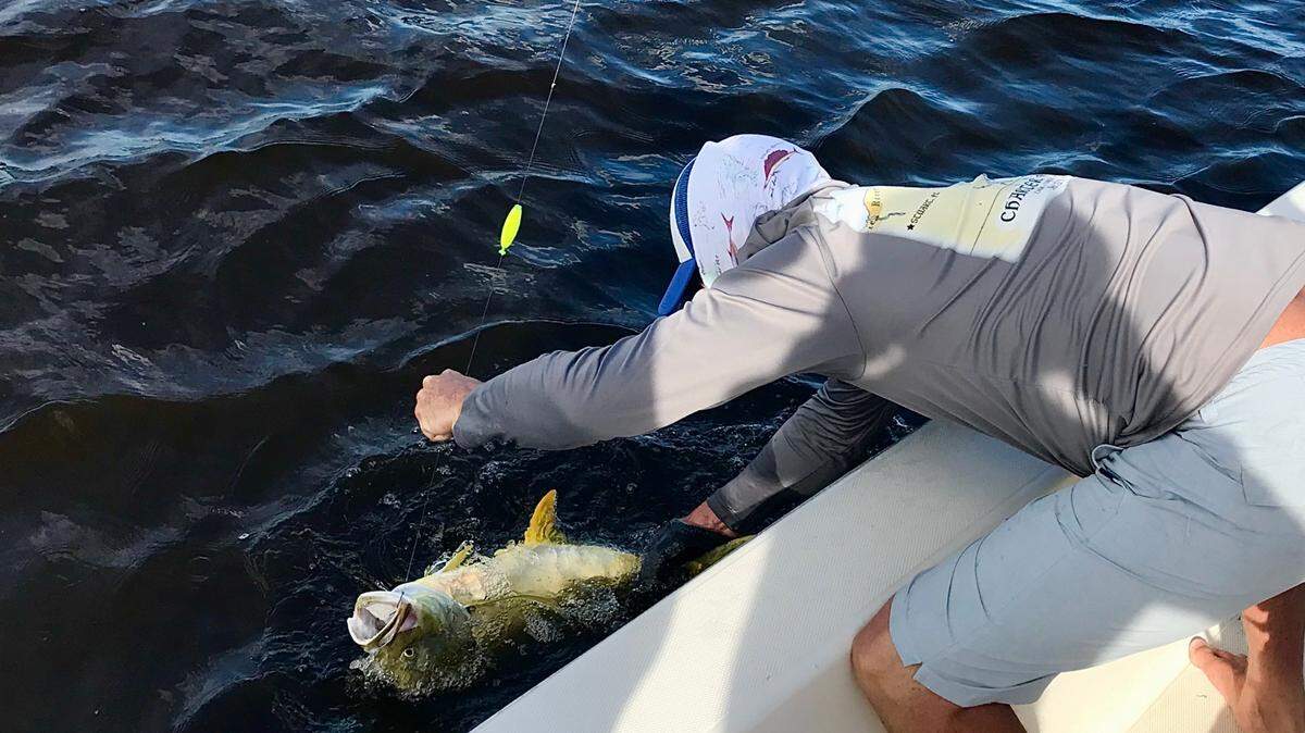Capt. Chris Murray of Crossroads Charter Fishing lands a nice jack crevalle that ate a live mullet in the St. Lucie River in Stuart for Tony Javarone of Lake Clarke Shores.