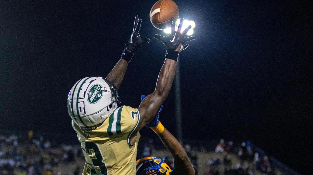 Miami Central wide receiver Khaleal Sterling makes a reception over Miami Northwestern defensive back Tywan Cox (5) during a high school football game at Traz Powell in Miami, Florida, on Friday, October 6, 2023.