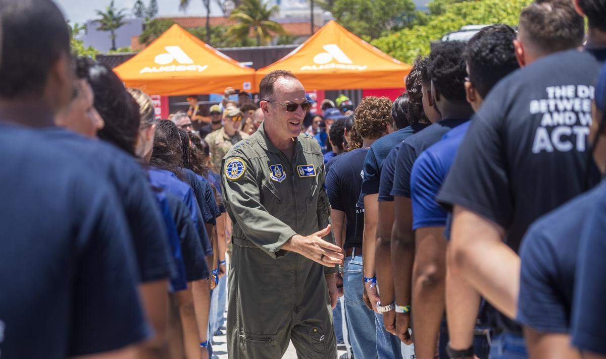 Lt General John P. Healy greets a group of future military members at a special Enlistment Swearing-In Ceremony honoring the next generation of American service members in South Beach during the Hyundai Air & Sea Show annual National returns Salute to America's Heroes for Memorial Day Weekend celebration, in Miami Beach, on Saturday, May 23, 2026