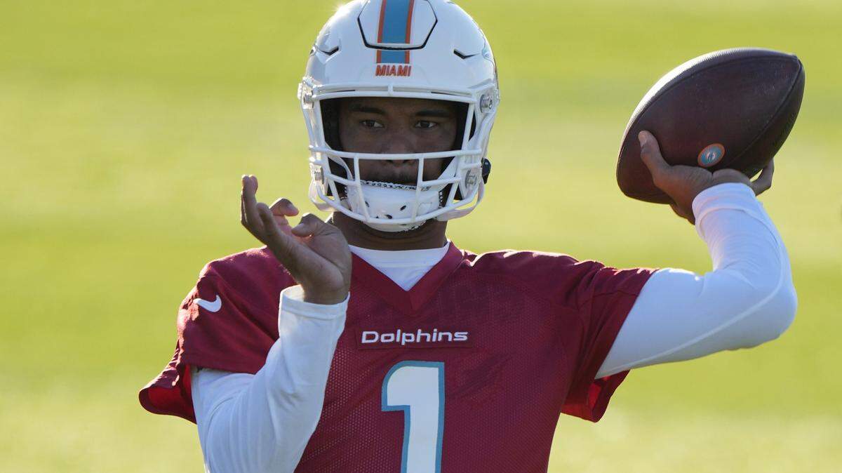 Dolphins quarterback Tua Tagovailoa throws the ball during a practice and media availability by the Miami Dolphins In Ware, England, Friday, Oct. 15, 2021. The Dolphins play the Jaguars in a regular season NFL game on Sunday at Tottenham Hotspurs White Hart Lane stadium in London. (AP Photo/Alastair Grant)