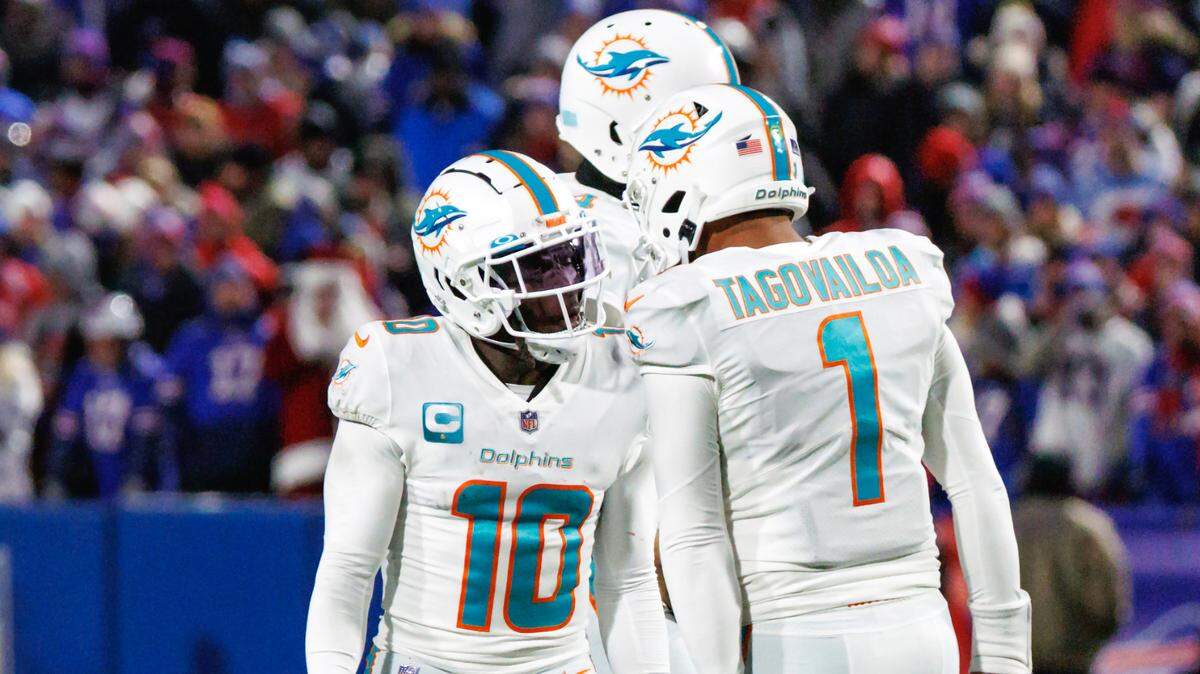 Miami Dolphins wide receiver Tyreek Hill (10) celebrates with teammate Tua Tagovailoa (1) after scoring a touchdown during third quarter of an NFL football game against the Buffalo Bills at Highmark Stadium on Saturday, December 17, 2022 in Orchard Park, New York.