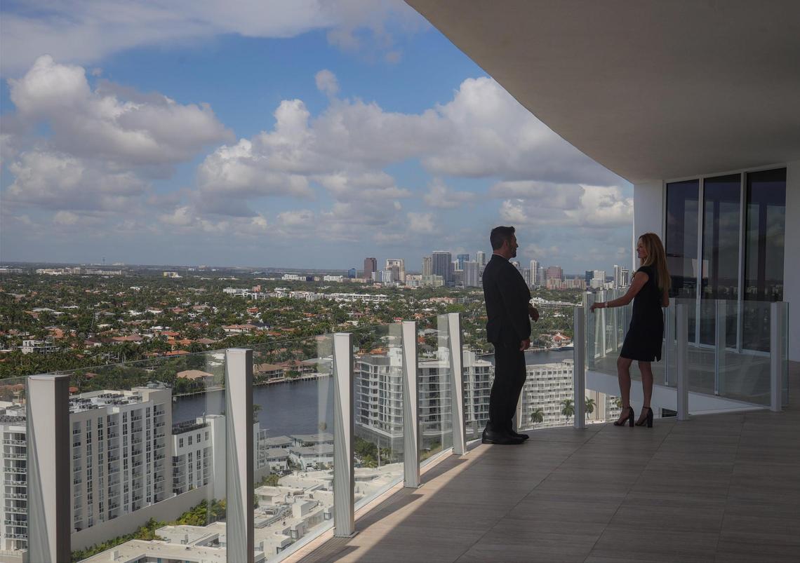 “Over the last three years,” said Julie Jones, VP of ultra luxury sales for Douglas Elliman, “Broward shifted from a second or third-home market to people making this their primary residence.” Above: Dan Teixeira, director of sales Douglas Elliman Development Marketing (left) and Julie Jones, VP of ultra luxury sales for Douglas Elliman (right) take in the downtown skyline from a penthouse apartment balcony at the Four Seasons Hotel and Residences in Fort Lauderdale, Florida.