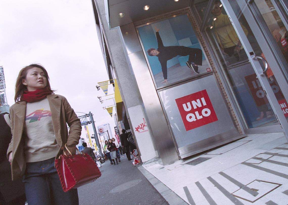 A pedestrian peers into Uniqlo's flagship store in Harajuku, one of Tokyo, Japan's trendiest shopping areas, in this file photo from March 8, 2001. The popular fashion retailer plans to open stores on Lincoln Road and at Aventura Mall in 2026.