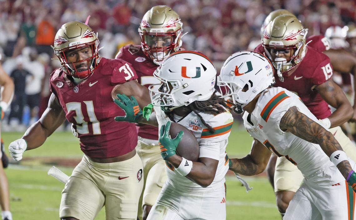 Florida State Seminoles linebacker Elijah Herring (31) attempts to tackle Miami Hurricanes wide receiver Malachi Toney (10) on a pass reception in the first half at Doak Campbell Stadium in Tallahassee, Florida, on Saturday, October 4, 2025.