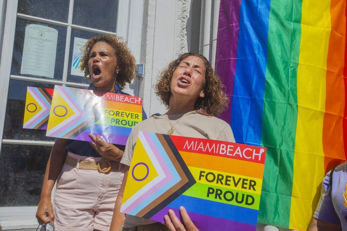 From left, Salome Milan and Lilia Tome rally with other demonstrators carrying rainbow flags and signs reading ‘Miami Beach Forever Proud’ and ‘Won’t Be Erased’ during the Forever Proud March on Ocean Drive in Miami Beach, Fla., Sunday, Aug. 31, 2025. The march followed state officials’ order to remove the city’s LGBTQ Pride crosswalk.