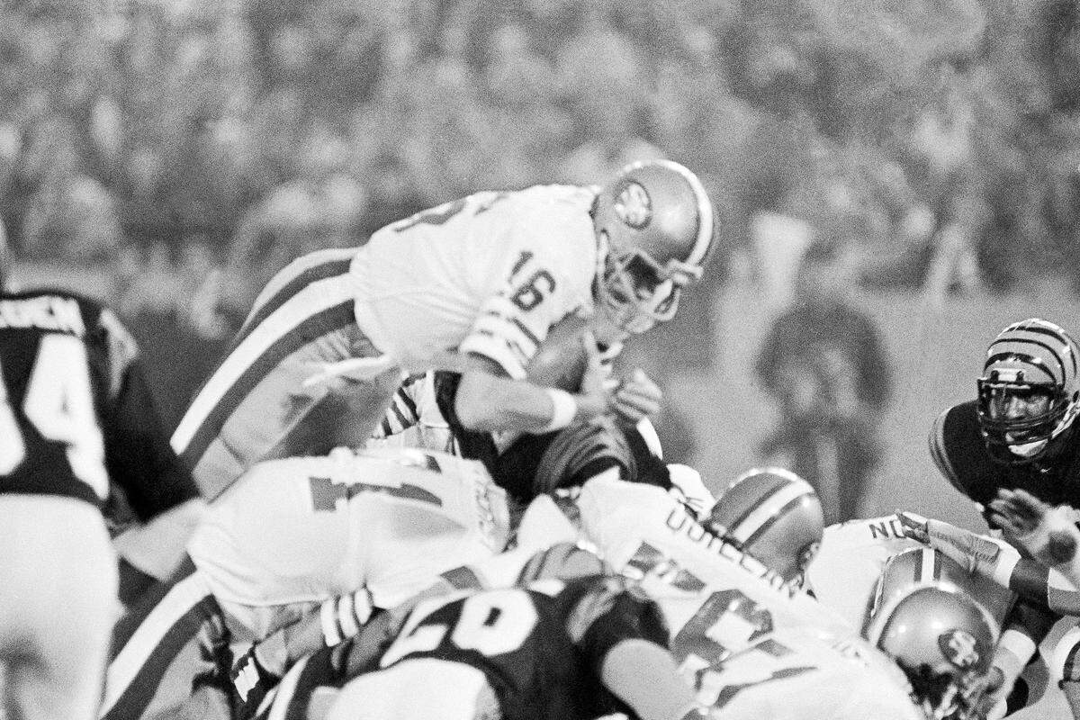 San Francisco 49ers quarterback Joe Montana sneaks across the goal line for the 49ers first score in the first quarter of Super Bowl XVI against Cincinnati at the Pontiac Silverdome.