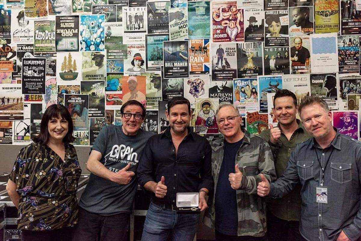 Miami Beach Commissioner Michael Góngora presents a key to the city in 2019 to the Manchester, England, band New Order. In January, he presented a proclamation to the band at its concert at the Fillmore Miami Beach. The general manager of the concert hall complained to the city that Góngora brought up a contract vote after being denied a free ticket. Góngora denies the claim.