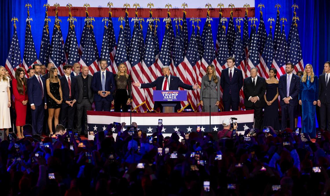 Republican presidential nominee former President Donald Trump speaks during his election night party flanked by family and friends at the Palm Beach County Convention Center on Tuesday, Nov. 5, 2024, in West Palm Beach, Fla.