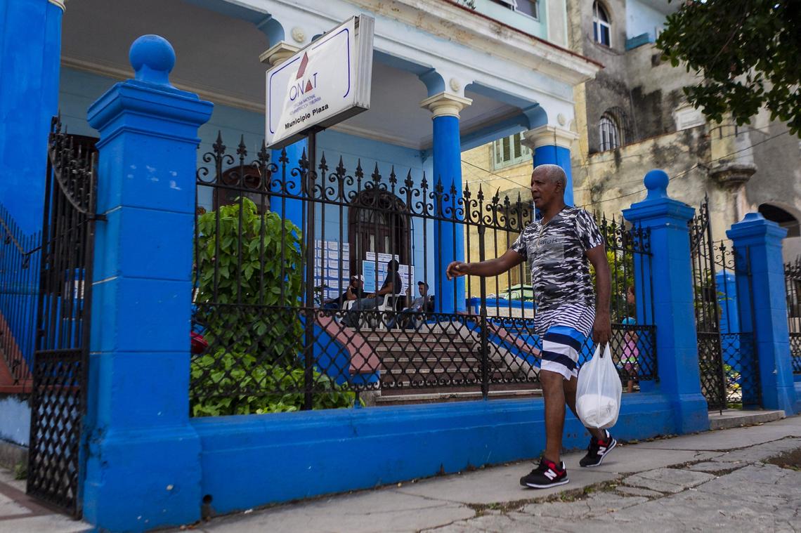 On the facade of the National Office of Tax Administration in Havana’s Plaza de la Revolucion, notices about Cuba’s new self-employment law are posted.