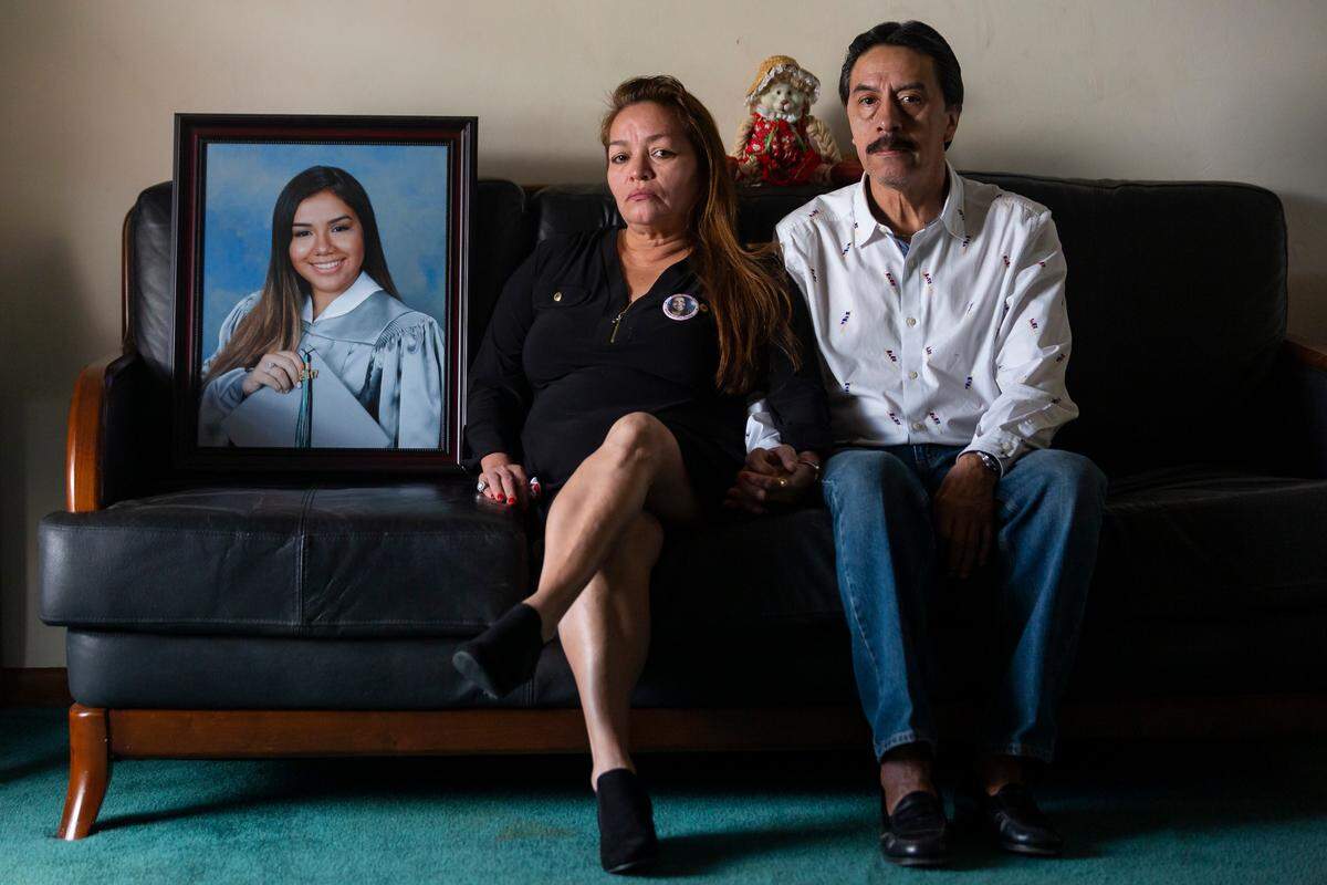Gina and Orlando Duran sit next to a photo of their daughter Alexa at their home in Miami, Florida, on Sunday, Dec. 23, 2018. Alexa Duran, 18, was driving her father’s car the day the FIU bridge collapsed. She was one of six people who died.