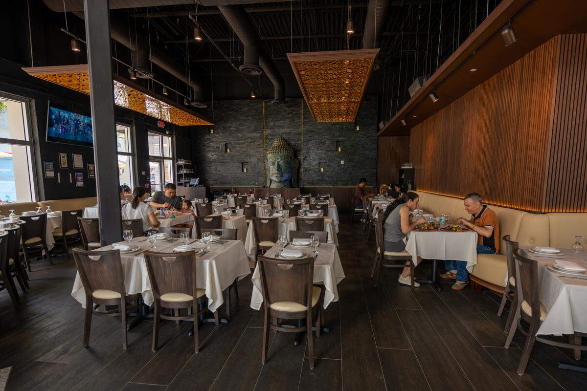 The dining room at Bombay Darbar Indian restaurant in Downtown Doral, which has a seven-foot Buddha statue on the far wall.