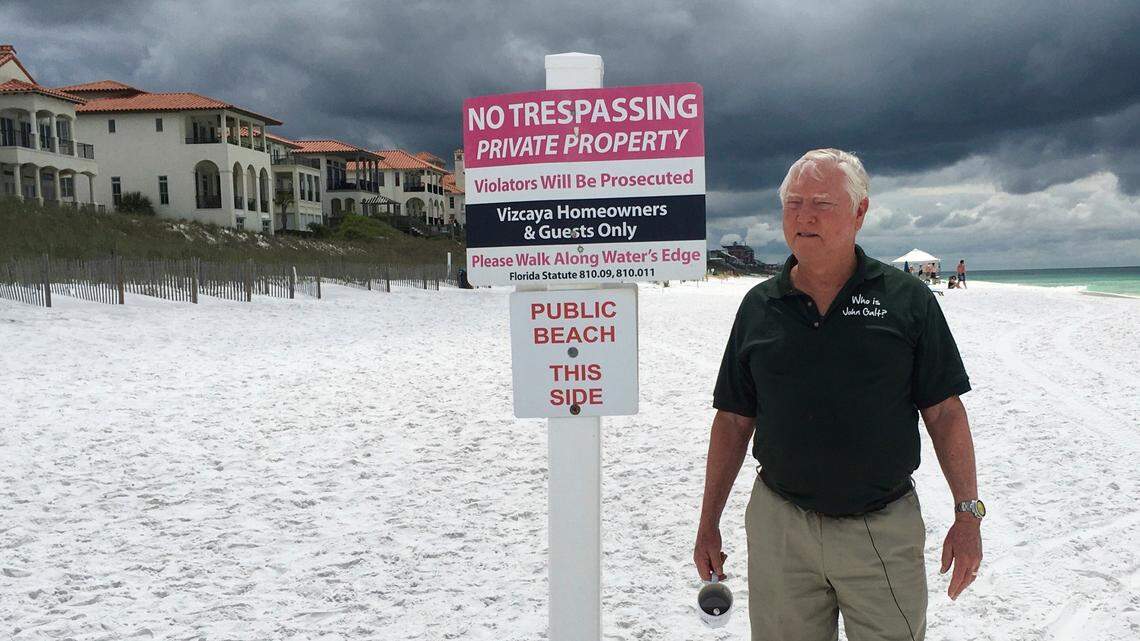 In this May 15, 2018, photo Bill Hackmeyer walks on the beach near his condo, in Santa Rosa Beach, Fla.  A new Florida law has reignited a fight over beach access in a Florida Panhandle county known for its pristine, sugar-white sand and rolling dunes, right in time for the July 4th holiday. Hackmeyer defends his fight to keep the public off of the private beach in front of his gated community. On Thursday, Gov. Rick Scott signed an executive order contradicting that law.