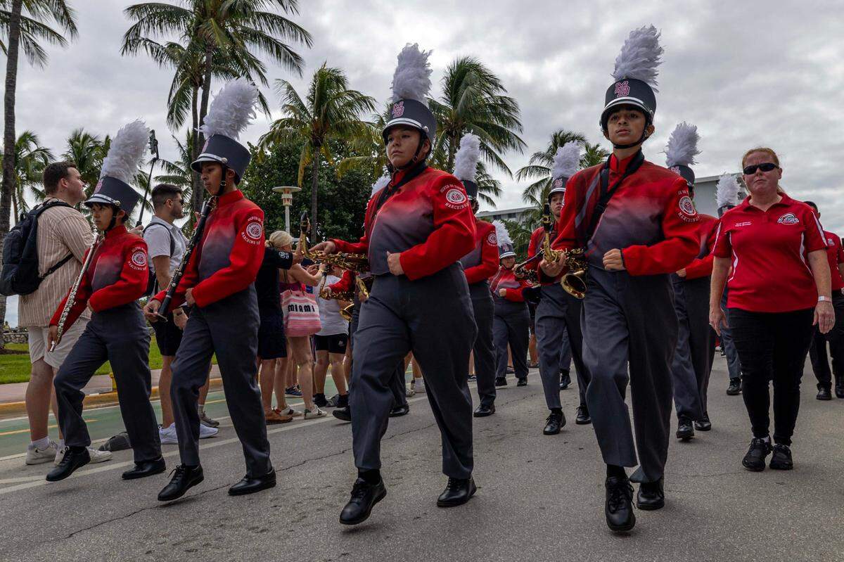 Members of the Miami Beach Hi Tides Silver marching Band march on the street during the 16th Annual Veterans Day Parade off Ocean Drive on Monday, Nov. 11, 2024, in Miami Beach, Fla.