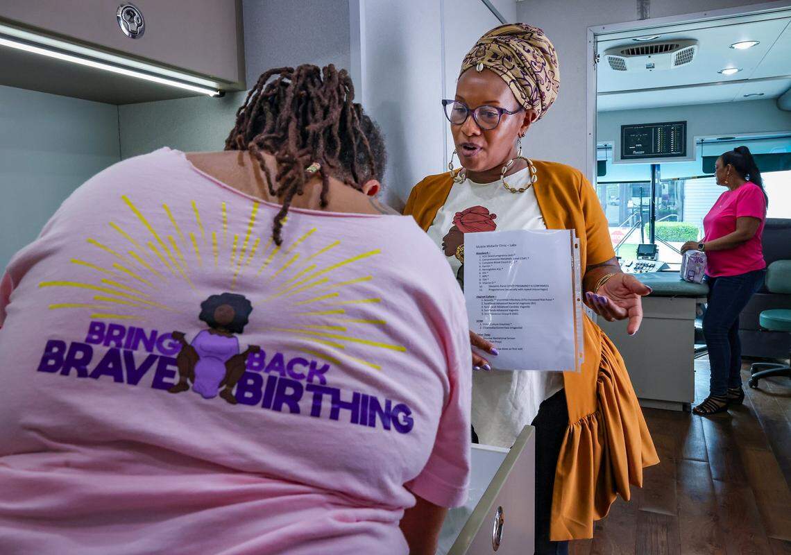 Sheila Simms Watson, head midwife at SBJN, left, and Jamarah Amani, executive director of the Southern Birth Justice Network, center, prepare for receiving clients as the Southern Birth Justice Network Mobile Midwife Unit opens for health services parked at Overtown Youth Center in Miami, Florida, on Thursday, April 16, 2026.