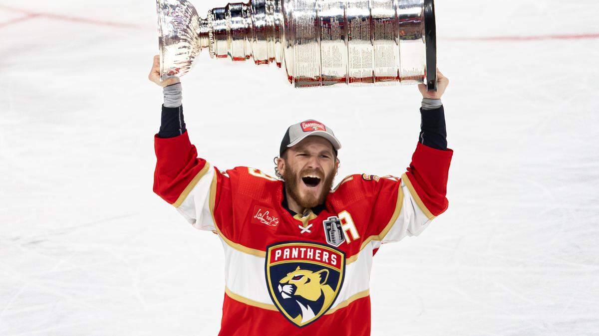 Florida Panthers left wing Matthew Tkachuk (19) lifts the Stanley Cup after the Panthers defeated the Edmonton Oilers in Game 7 of the NHL Stanley Cup Final at the Amerant Bank Arena on Monday, June 24, 2024, in Sunrise, Fla.