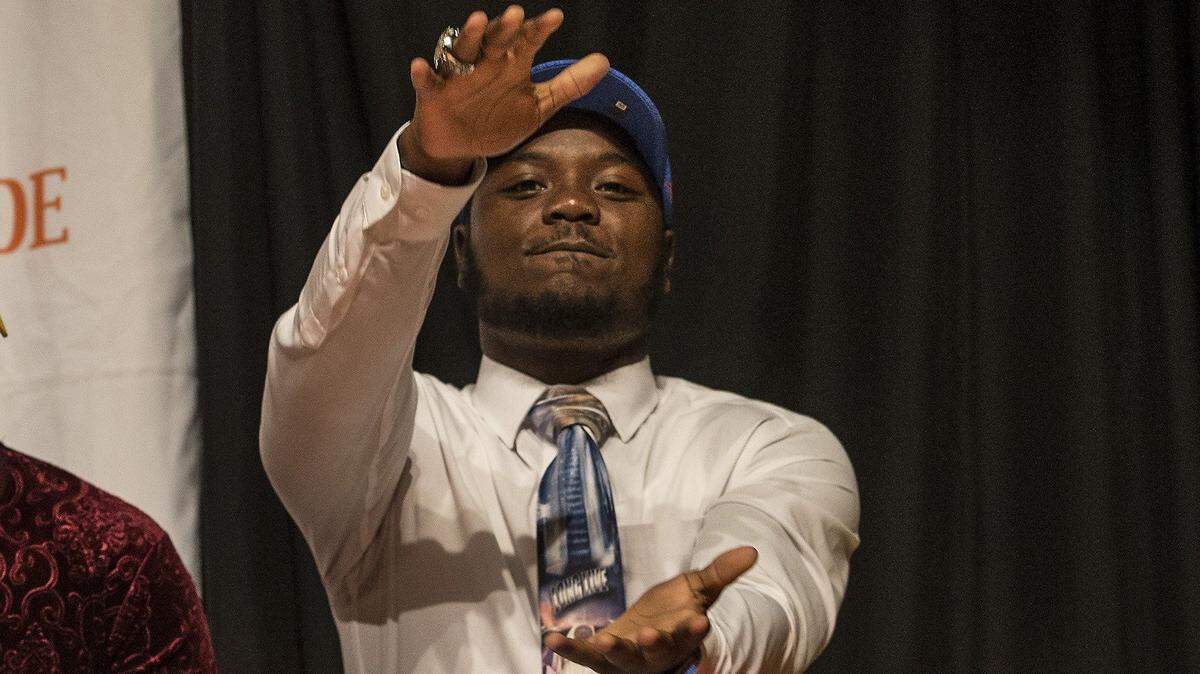 Carol City’s NayQuan Wright does the Gator Chomp as he signs with the University of Florida on Wednesday December 19, 2018.