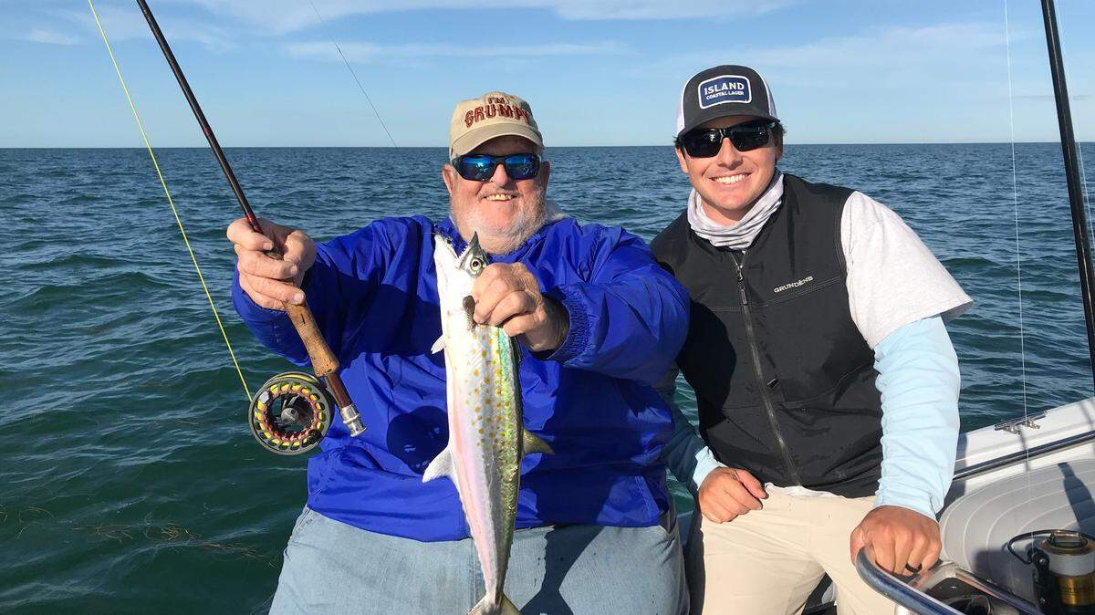 Retired Miami Beach charter fishing captain Bouncer Smith, left, holds one of the dozens of Spanish mackerel that he caught on a fly rod fishing in the Gulf of Mexico with Capt. Mike Venezia out of Bud N’ Mary’s Marina in Islamorada.