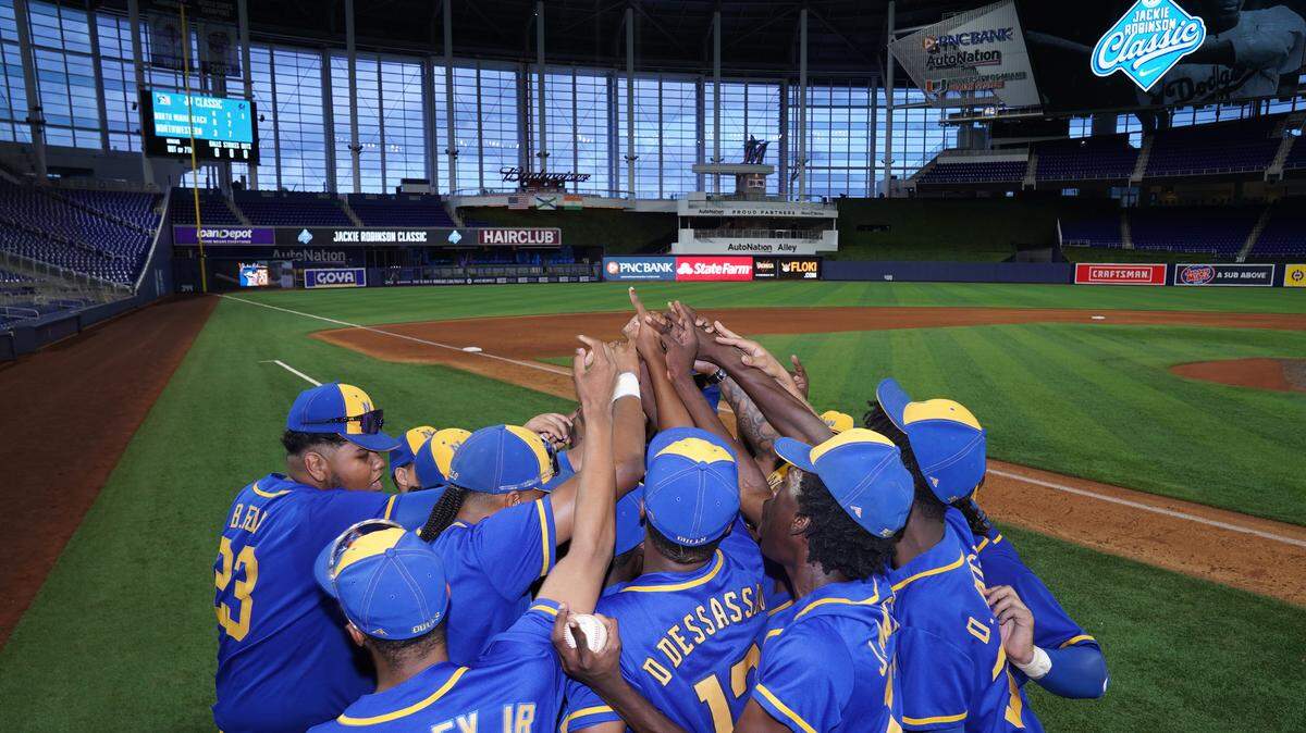 The Miami Northwestern baseball team celebrates after beating North Miami Beach High in the inaugural Jackie Robinson Classic at loanDepot park on Monday, April 18, 2022.