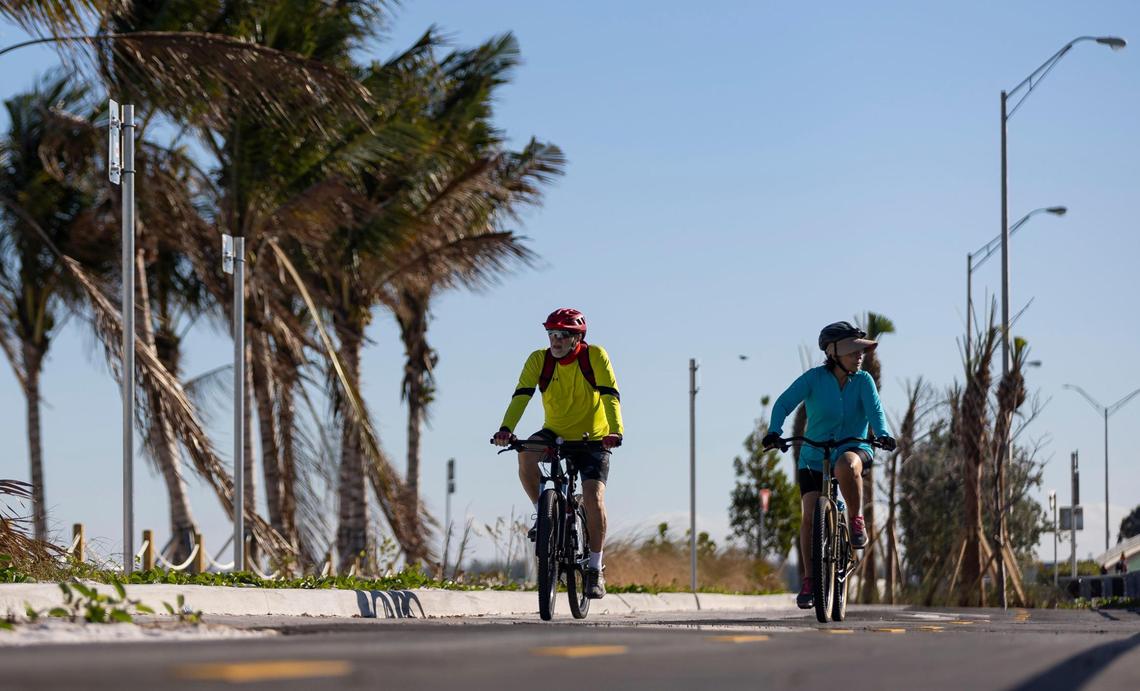 Cyclists make their way down a bike path at Hobie Island Beach Park North along the Rickenbacker Causeway.