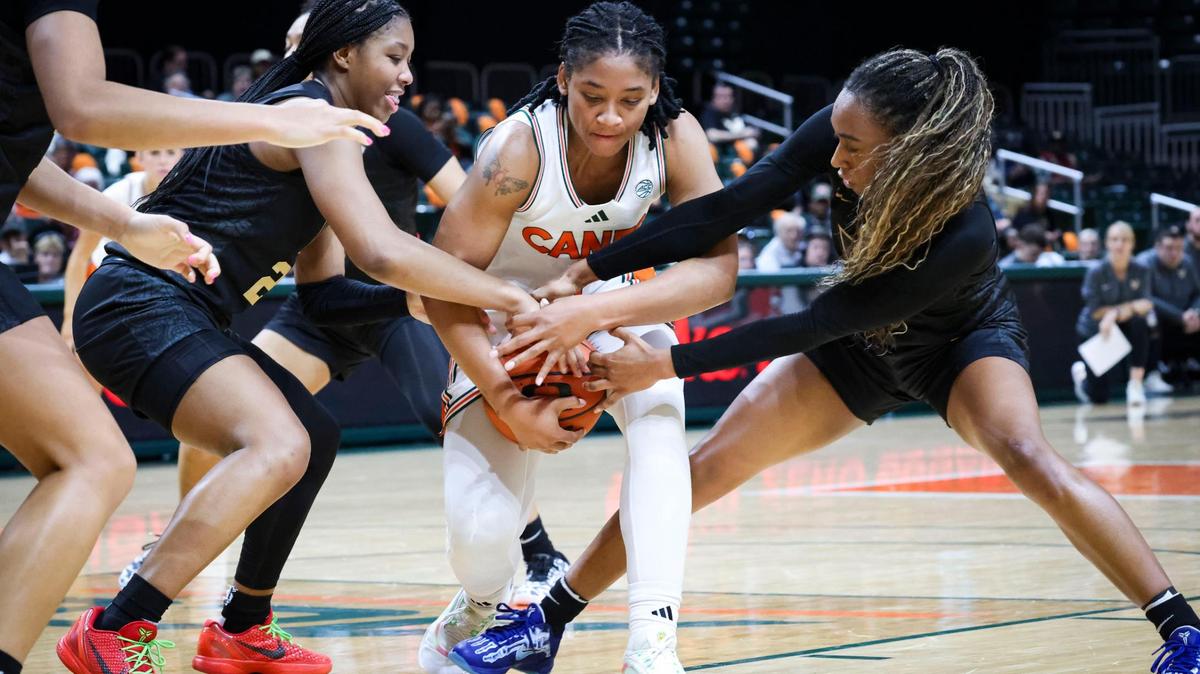 Vanderbilt Commodores Iyana Moore (23) and Mikayla Blakes (1) try to get the ball from Miami Hurricanes Jasmyne Roberts(4) during the fourth quarter of the game on Wednesday, Dec. 4, 2024, at Watsco Center in Coral Gables, Fla.