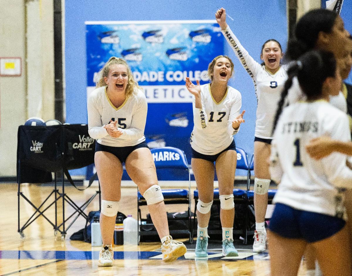 Deven Gonzalez, senior volleyball player for Miami High who suffered injuries to her left leg in the Surfside collapse, left, celebrates a win with her team on Tuesday, Oct. 4, 2022, at Miami Dade College campus in Kendall.