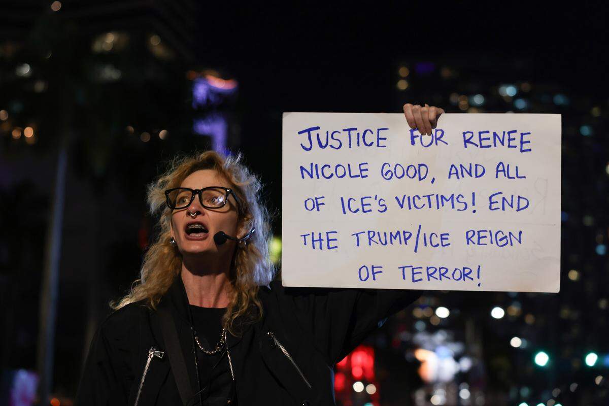 Kat Duesterhaus protests against ICE at the Torch of Friendship monument at 401 Biscayne Blvd., in downtown on Wednesday, Jan. 7, 2026, in Miami.