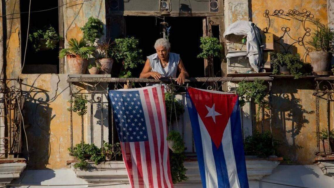 Javier Yanez stands on his balcony decorated with U.S. and Cuban flags in Old Havana in 2014.