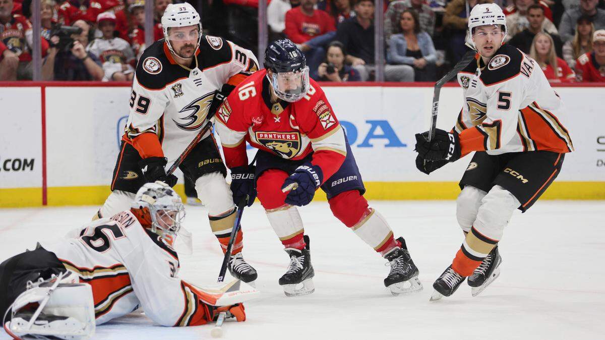 Jan 15, 2024; Sunrise, Florida, USA; Florida Panthers center Aleksander Barkov (16) passes the puck as Anaheim Ducks goaltender John Gibson (36), center Sam Carrick (39), and defenseman Urho Vaakanainen (5) defend during the second period at Amerant Bank Arena.