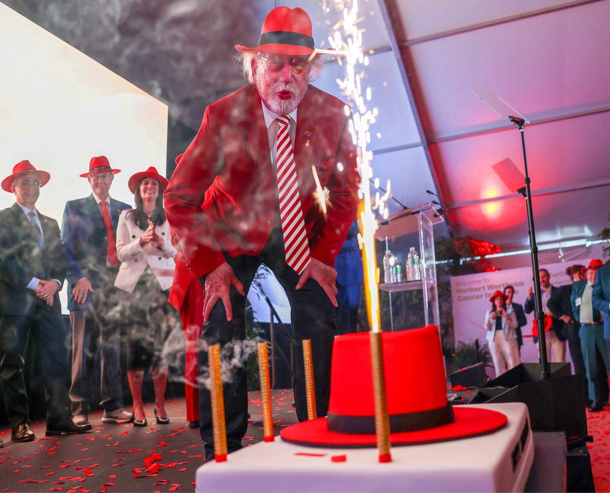 Dr. Herbert Wertheim tries to blow out sparklers on his birthday cake during a celebration of his upcoming birthday, concluding the event honoring his historic philanthropic gift to Baptist Health.