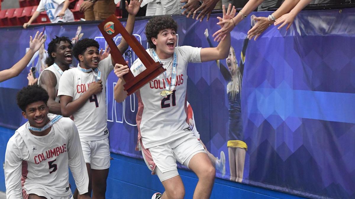 Columbus players celebrate their State Championship with fans after beating Oak Ridge in the Class 7A final during the Florida High School State Championships at the RP Funding Center in Lakeland, Fl on Saturday March 9, 2024. Columbus defeated Oak Ridge 72-67 in overtime. Scott Wheeler | Photo