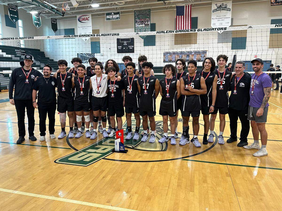 Southwest Miami High’s boys’ volleyball team celebrates after winning the GMAC tournament championship on Tuesday night at the Hialeah Gardens High gym.