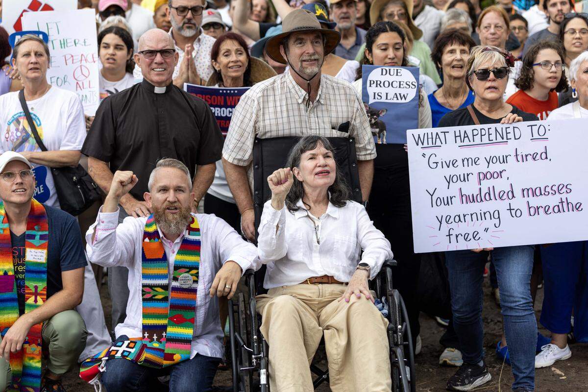 A group of interfaith activists react during a vigil in August outside Alligator Alcatraz, the migrant detention center built over the summer in the Florida Everglades.