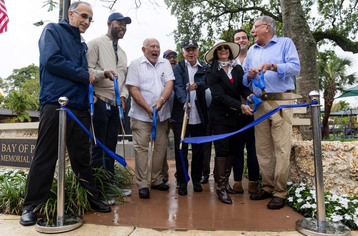 District 4 Commissioner Manolo Reyes, far right, cuts a ribbon during a commemoration event at the Bay of Pigs Memorial Park on Wednesday, April 12, 2023, in Miami. Reyes unveiled a new monument to honor the Cubans who participated in the Bay of Pigs Invasion and showed improvements made to the park.