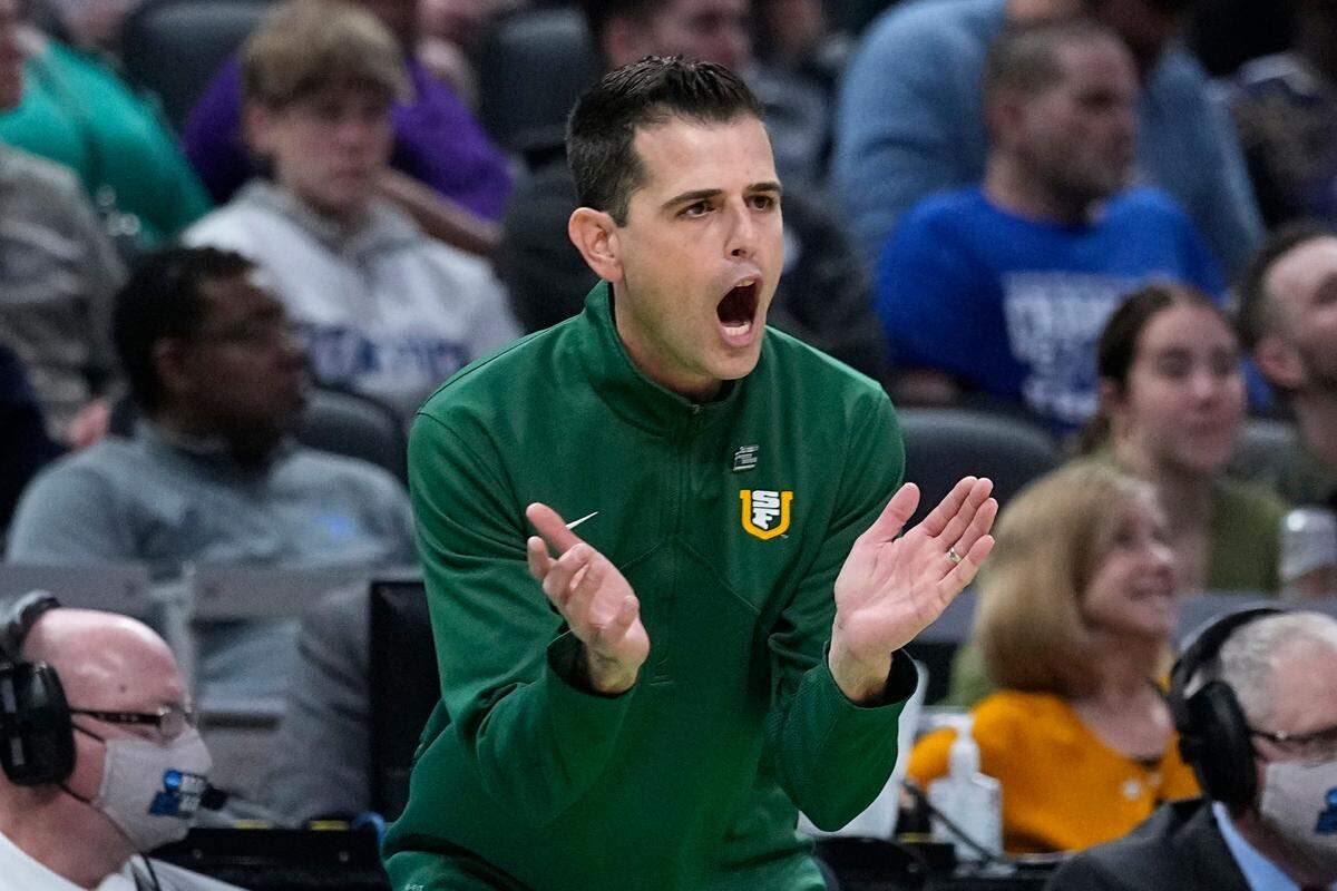 San Francisco head coach Todd Golden applauds his team during the first half of a college basketball game against Murray State in the first round of the NCAA tournament, Thursday, March 17, 2022, in Indianapolis.