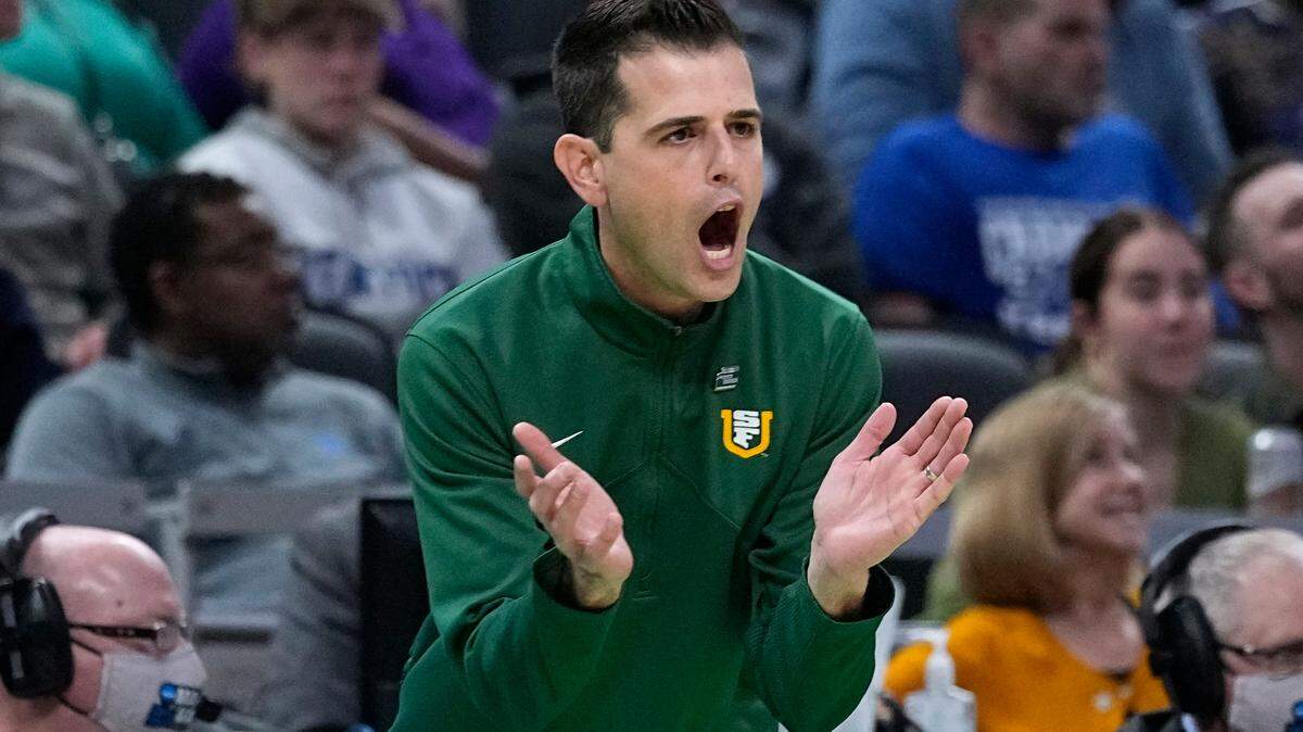 San Francisco head coach Todd Golden applauds his team during the first half of a college basketball game against Murray State in the first round of the NCAA tournament, Thursday, March 17, 2022, in Indianapolis.
