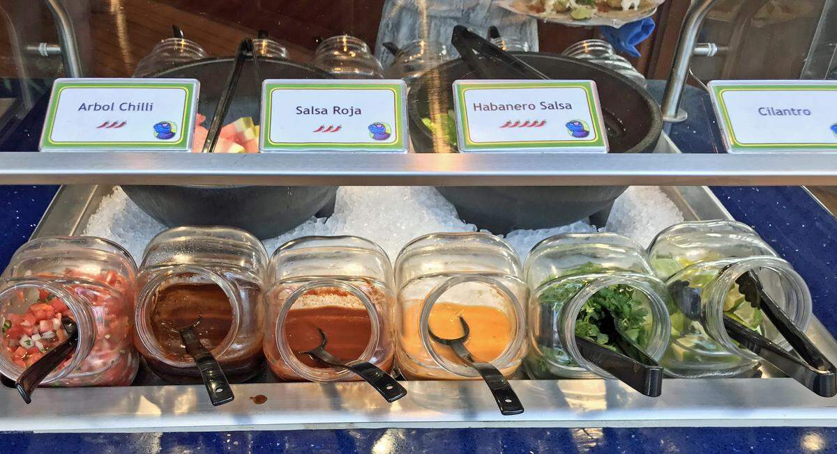 The condiment bar at BlueIguana Cantina lets customers further customize their tacos and burritos.