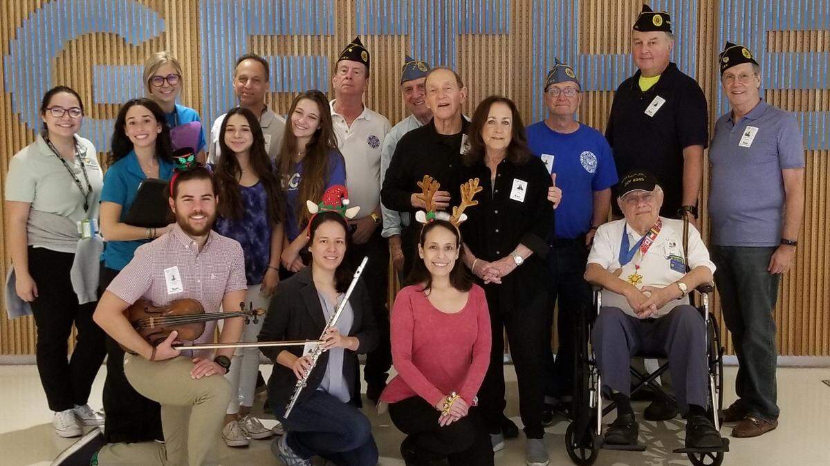 Volunteers with the Hearing Research Institute and Post #243 Coral Gables JWV USA visited 200 children at Nicklaus Children’s Hospital to share time, music and gifts. Bottom row, from left, Craig Garmendia; Jennifer and Christina LaLama; and Ainslee R. Ferdie. Middle row, from left, Diana Ramirez, Beke Pickard, Maia Snyder, Bella Cance’l, and Robert and Susan Pickard. Back row, from left, Child Life Activity Coordinator Kara Schroeder, Roger Snyder, Steve Jockers, David Magidson, Ike Heller, Dave Patlak, and Ron Stearn.