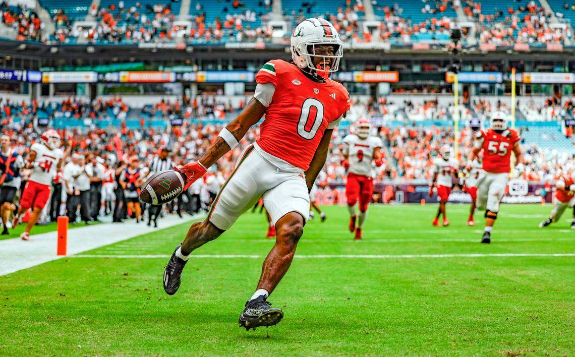 Miami Hurricanes wide receiver Brashard Smith (0) scores in the first half against the Louisville Cardinals on Saturday, November 18, 2023.